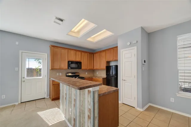 a kitchen that has a cabinets and a stove top oven