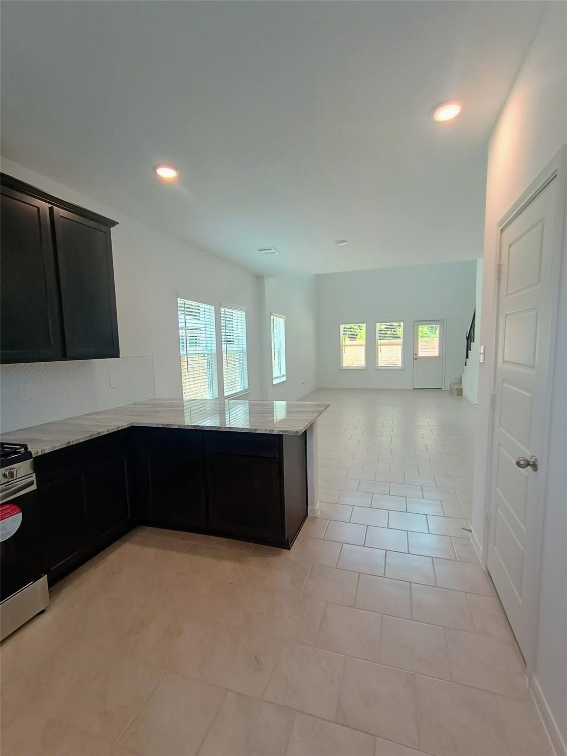 15924 Cy Young Court Splendora, TX 77372 - Photo 9 of 29 a kitchen with granite countertop white cabinets and window