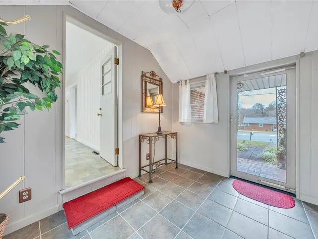 a room with lots of furniture and a potted plant