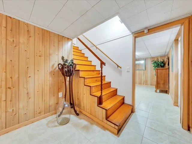 a view of a livingroom with furniture and stairs