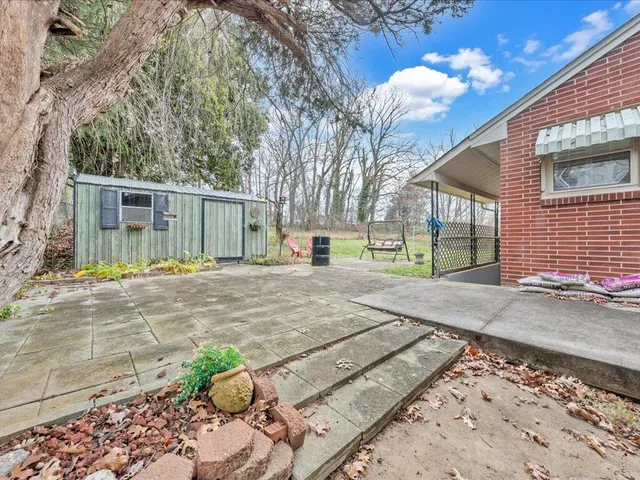 a view of a backyard with a patio
