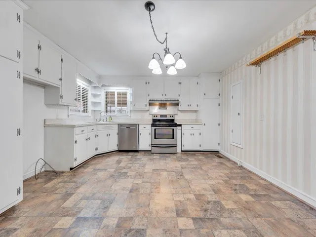 a view of a kitchen with electric appliances