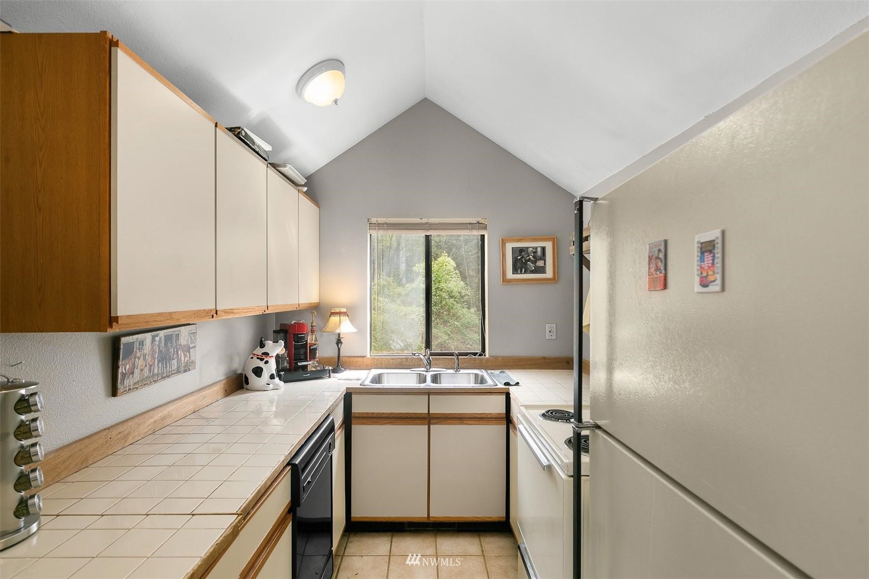 20712 29th Avenue Southeast Bothell, WA 98021 - Photo 23 of 40 a kitchen with a sink and a refrigerator
