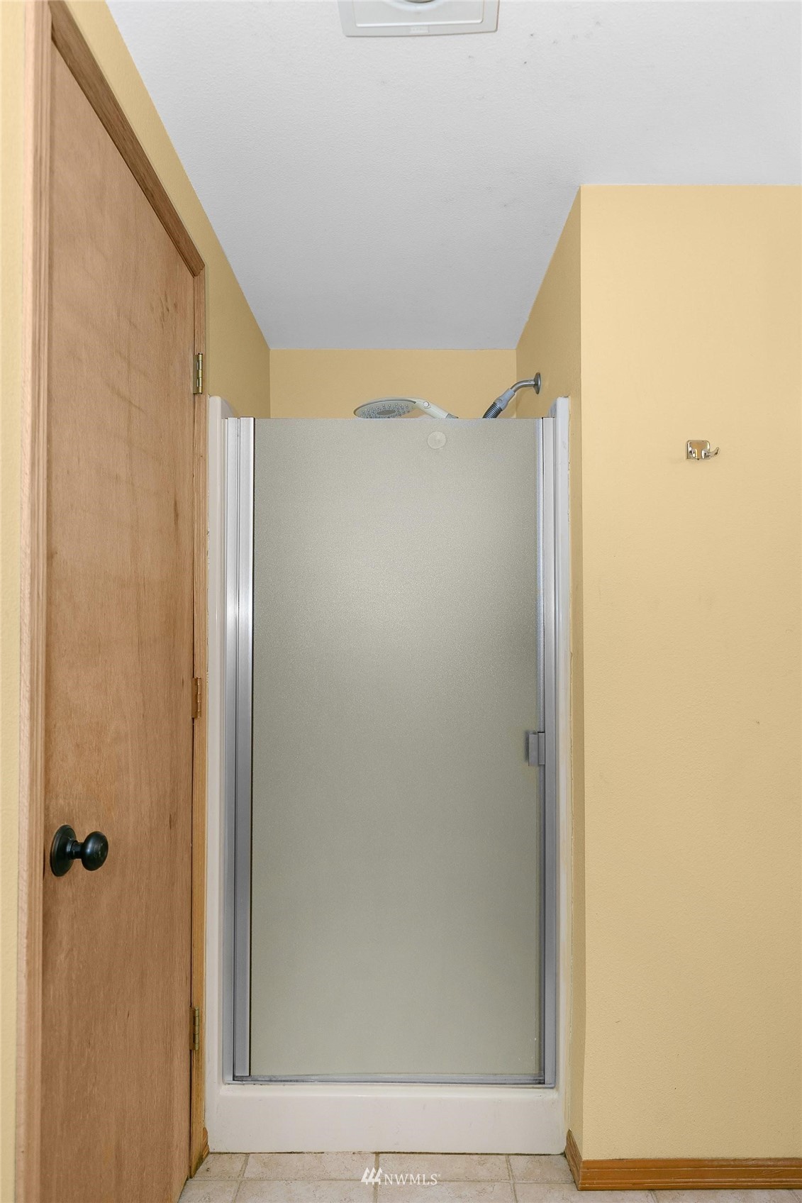 20712 29th Avenue Southeast Bothell, WA 98021 - Photo 25 of 40 a bathroom with a glass shower door and a window