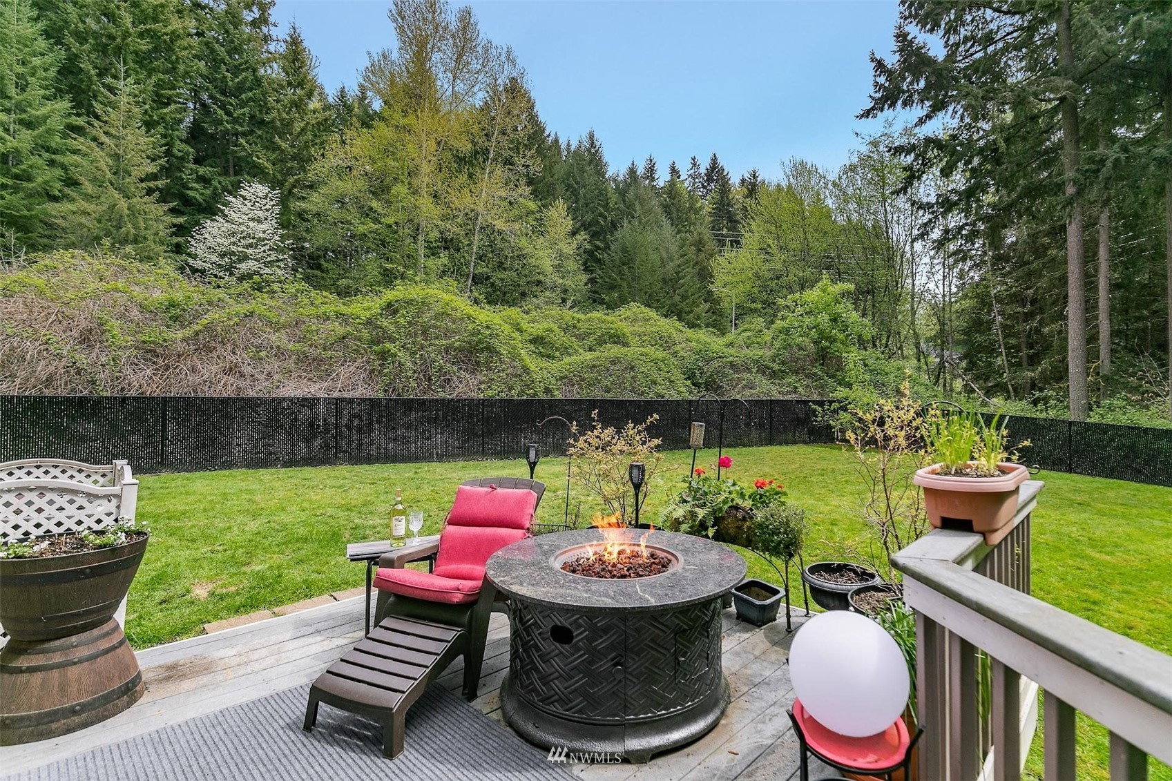 20712 29th Avenue Southeast Bothell, WA 98021 - Photo 35 of 40 a view of a backyard with table and chairs potted plants and a fire pit