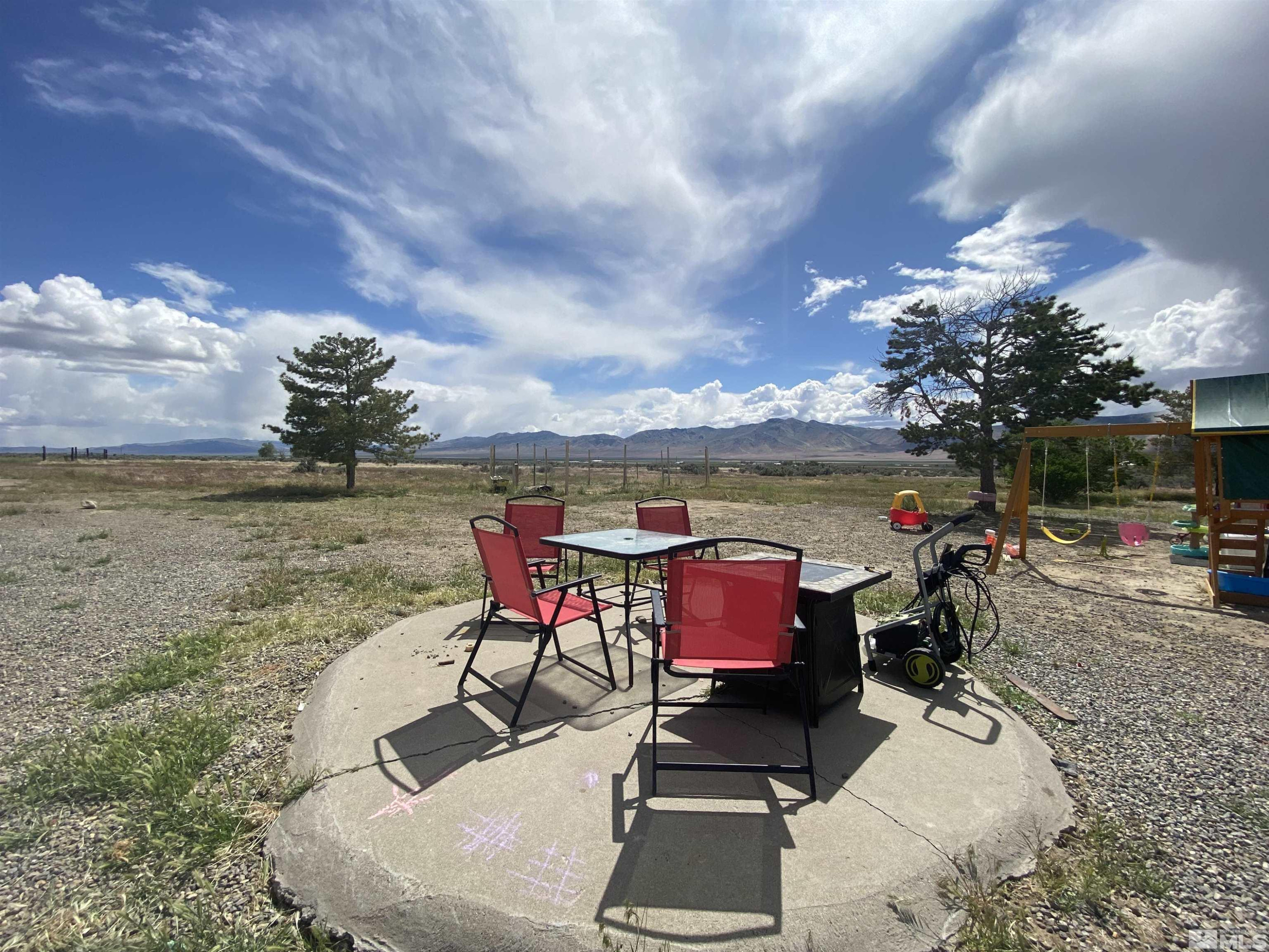 695 Good Choice Road Winnemucca, NV 89445 - Photo 16 of 29 a roof deck with table and chairs and potted plants