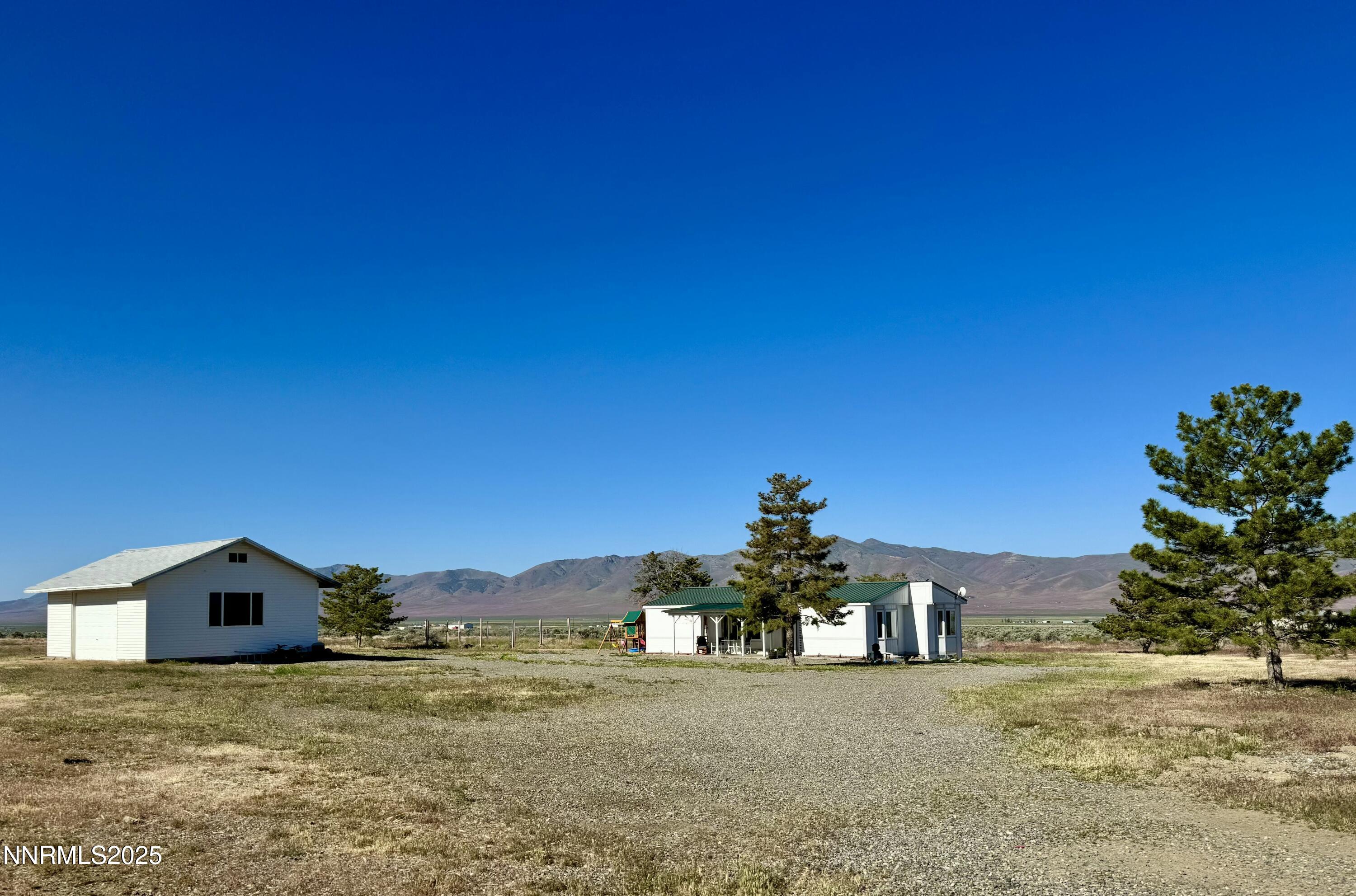 695 Good Choice Road Winnemucca, NV 89445 - Photo 26 of 29 a view of a large house with a yard