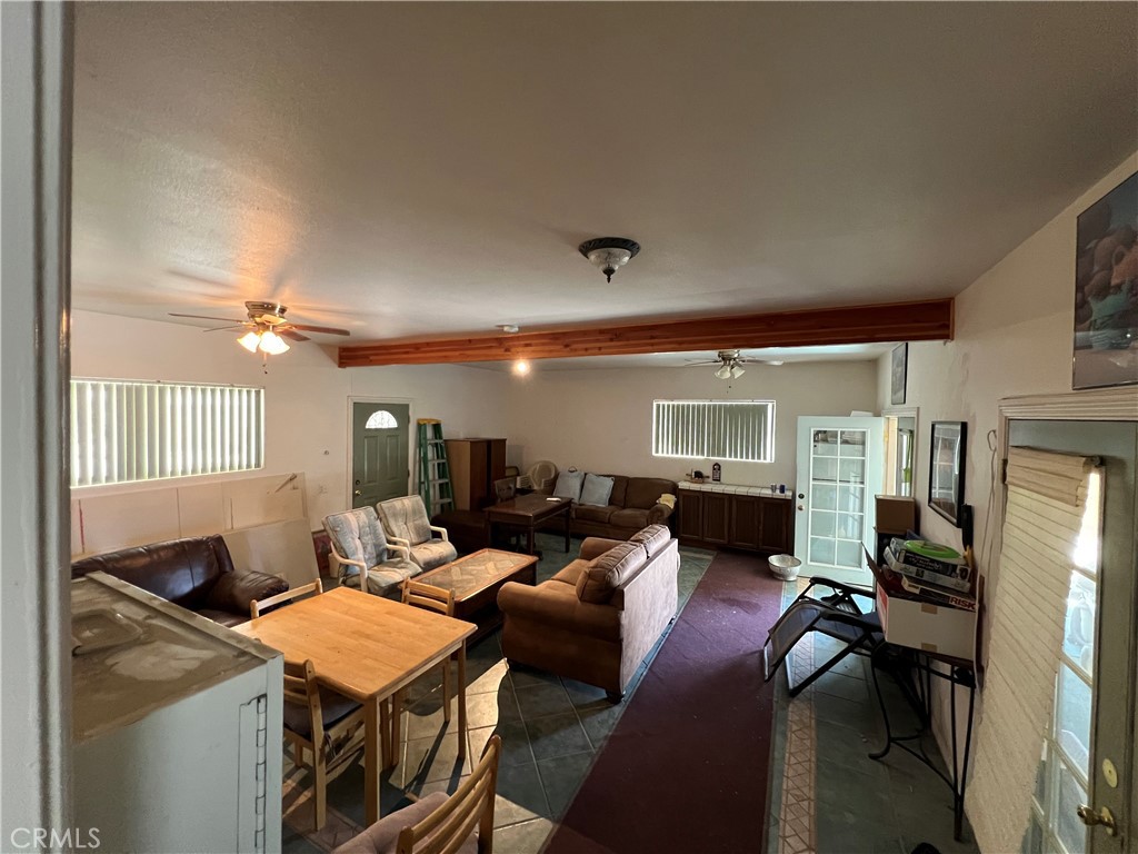 10369 Fairlane Road Lucerne Valley, CA 92356 - Photo 2 of 12 a living room with furniture a fireplace and a flat screen tv
