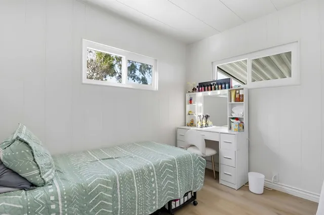 a bedroom with a bed and a bookshelf