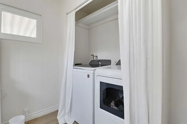 a close view of a utility room with dryer and washer