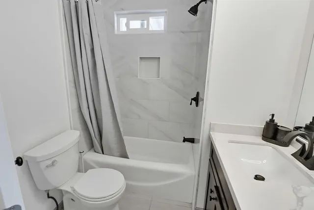 a bathroom with a sink a toilet and a bathtub