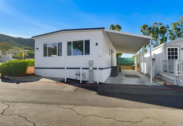 a view of a white house with a yard