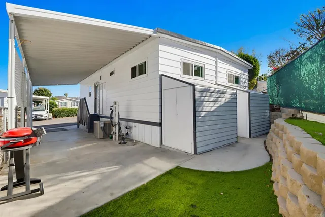 a view of a house with backyard and sitting area