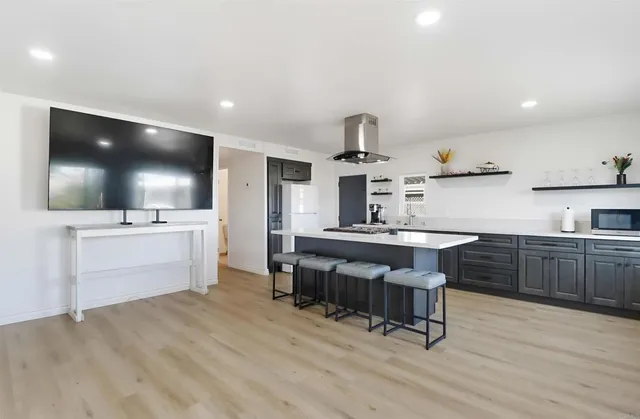 a kitchen with a sink cabinets and wooden floor
