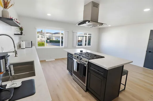 a kitchen with stainless steel appliances granite countertop a stove and a sink