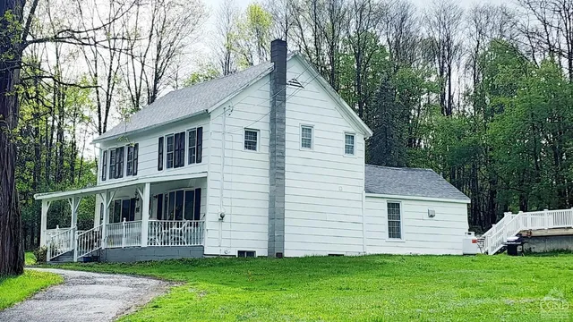 a view of a house with yard and tree s