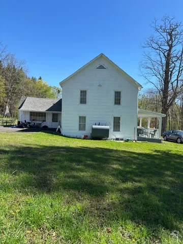 a front view of house with yard and green space