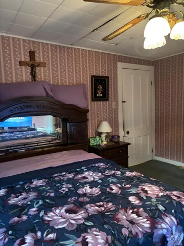a bedroom with bed and a window
