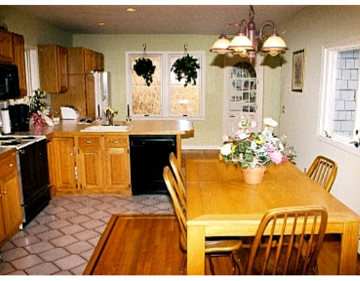 38 R County Road Andover, MA 01810 - Photo 3 of 4 a dining room with chandelier and wooden floor