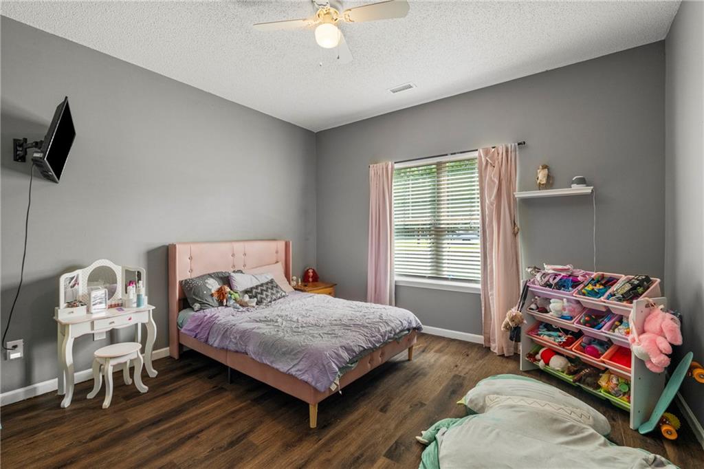234 Owens Road Fort Mitchell, AL 36856 - Photo 16 of 25 Bedroom with wood finished floors, baseboards, a textured ceiling, and ceiling fan