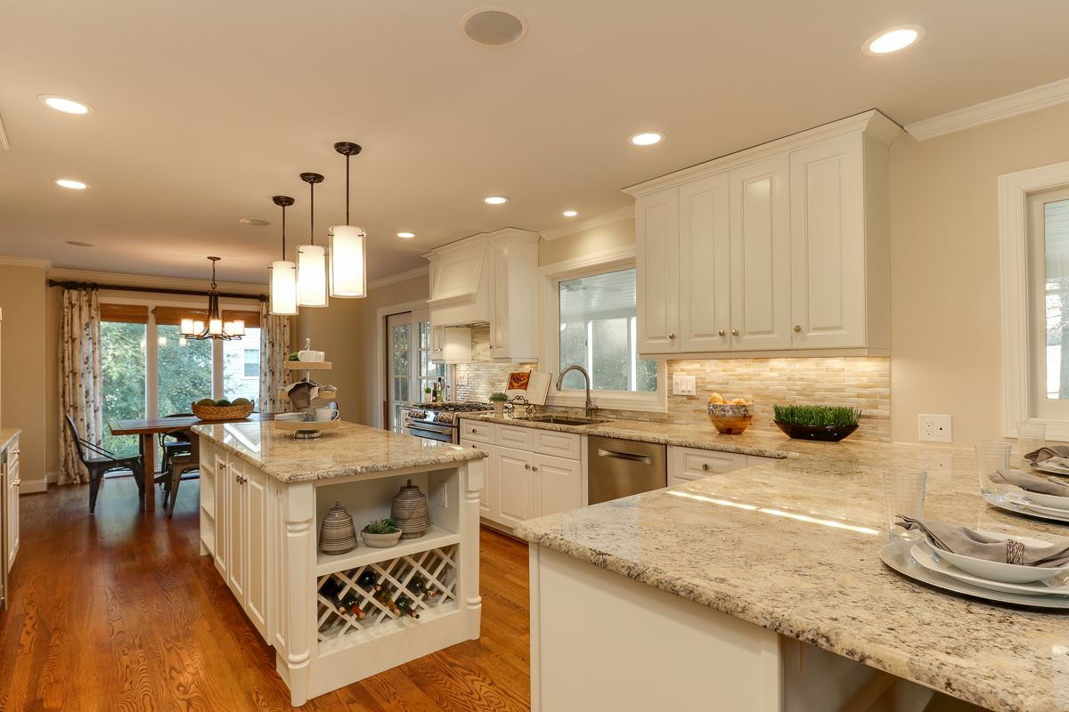 7009 North Ridge Drive Raleigh, NC 27615 - Photo 8 of 25 Kitchen was completely renovated in 2012, center island, white cabinetry, light granite, gas range, wine frig, dining counter with room for 3 barstools. Kitchen