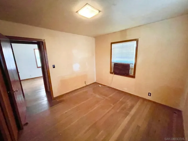 an empty room with mirror and stairs