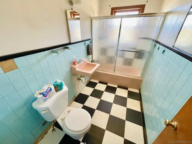a bathroom with a sink a toilet and a shower