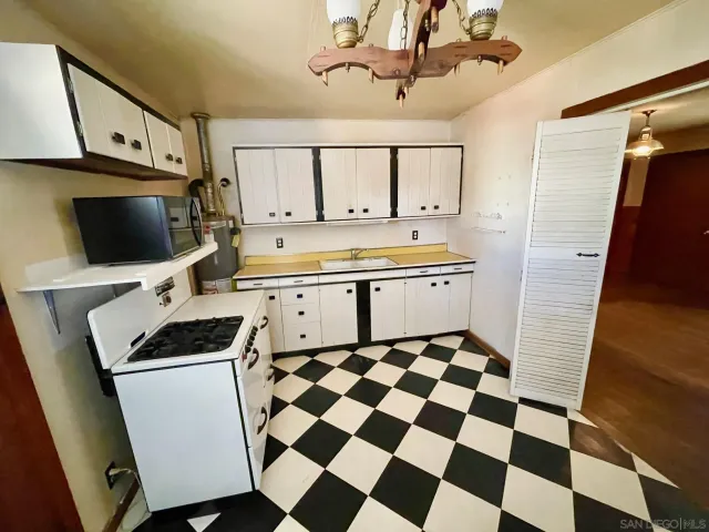 a kitchen with a sink a stove and microwave