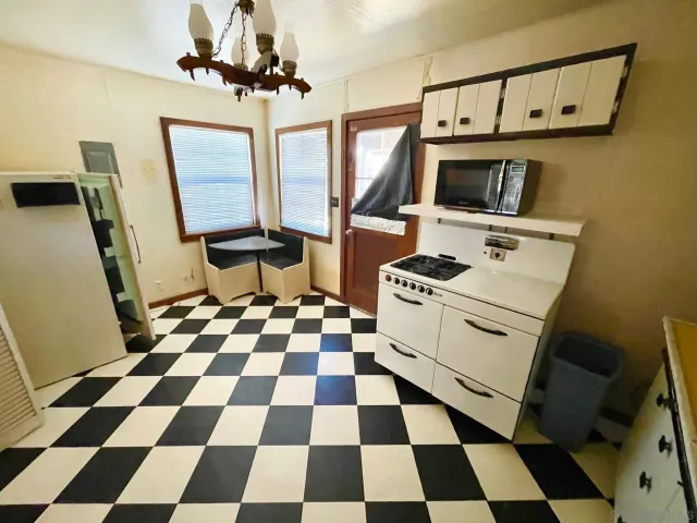 a kitchen with a stove a sink and a microwave