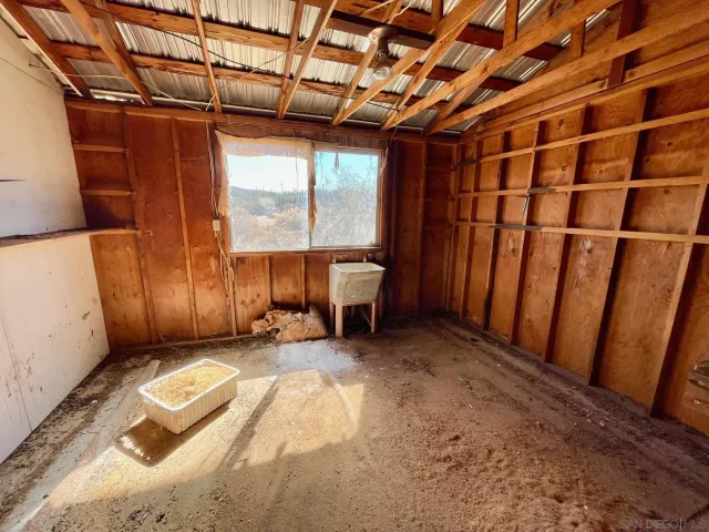 a view of a room with wooden floor and furniture