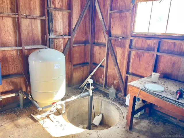 a view of a dry yard with trees