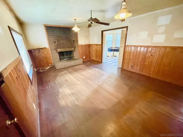 wooden floor in an empty room with a fireplace