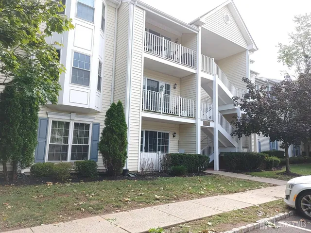 a view of a brick building next to a yard