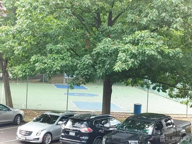a view of a street with parked cars