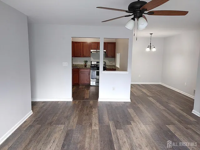 a view of an empty room with a ceiling fan
