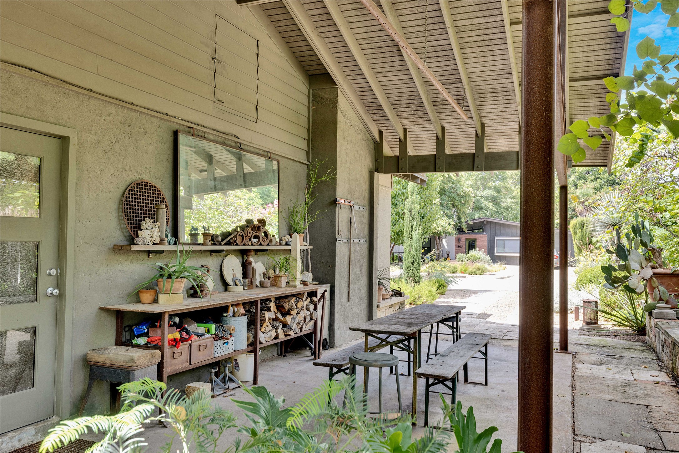1306 Norwood Road, Unit A Austin, TX 78722 - Photo 19 of 21 An inviting covered patio offers a tranquil outdoor living space, perfect for entertaining or quiet contemplation.