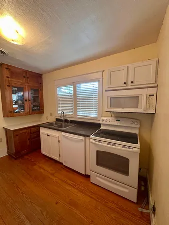 a living room with furniture a flat screen tv and a window