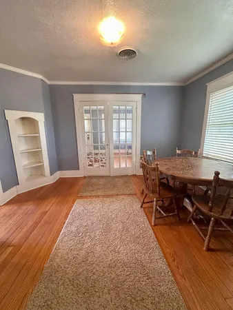 a view of a room with wooden floor and windows