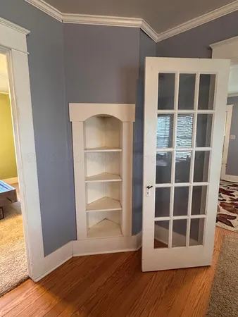 a kitchen with a refrigerator a sink and wooden floor