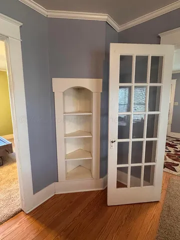 a kitchen with a refrigerator a sink and wooden floor