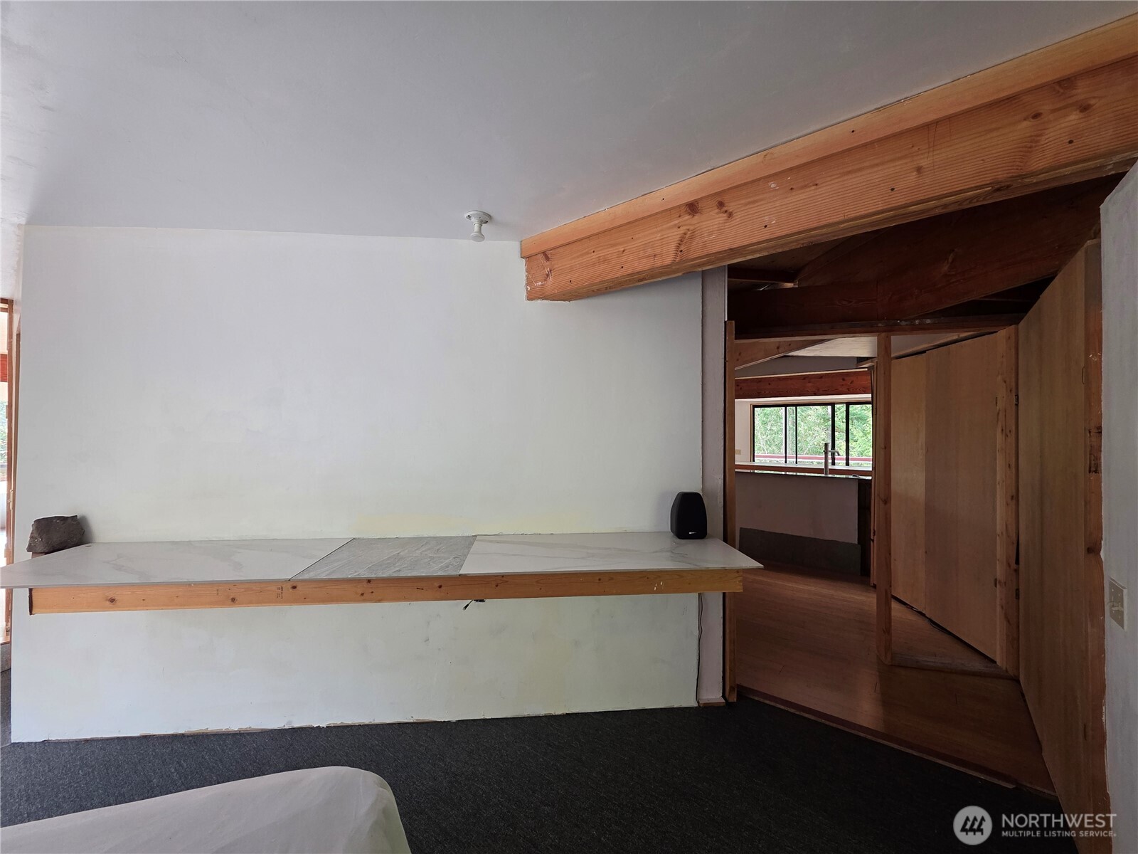 5612 Cape George Road Port Townsend, WA 98368 - Photo 11 of 17 a room with a couch and a window