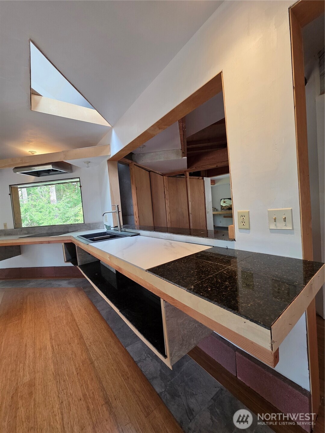 5612 Cape George Road Port Townsend, WA 98368 - Photo 7 of 17 a kitchen with wooden floors and a stove