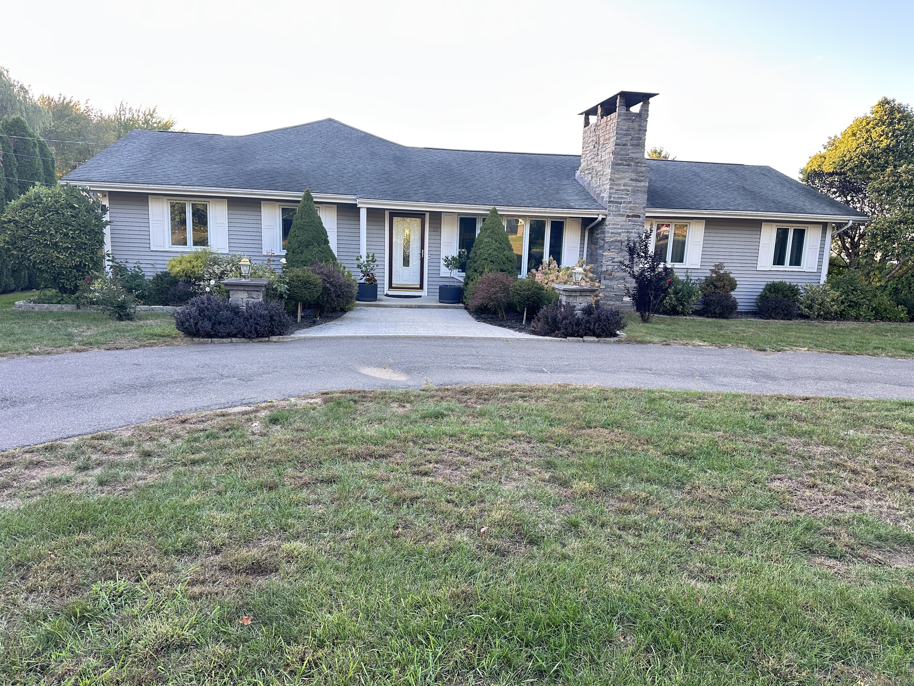 37 Ridge Road South Windsor, CT 06074 - Photo 1 of 1 a front view of a house with a garden