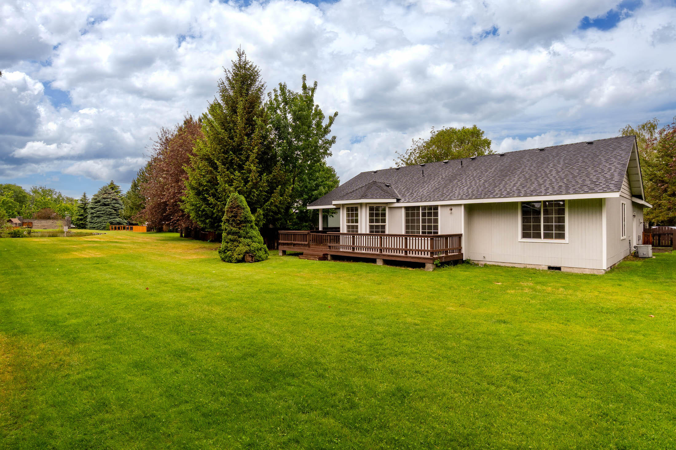 3389 Northeast Stonebrook Loop Bend, OR 97701 - Photo 24 of 27 Western view of the spacious rear lawn from the Southeast corner maintained by the HOA.