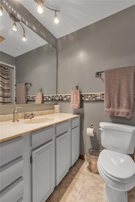 124 Heath Drive Baden, PA 15005 - Photo 16 of 38 a bathroom with a toilet sink and mirror