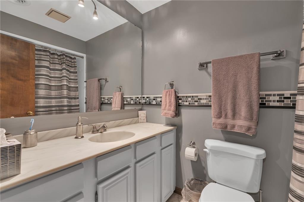 124 Heath Drive Baden, PA 15005 - Photo 17 of 38 a bathroom with a toilet sink and mirror