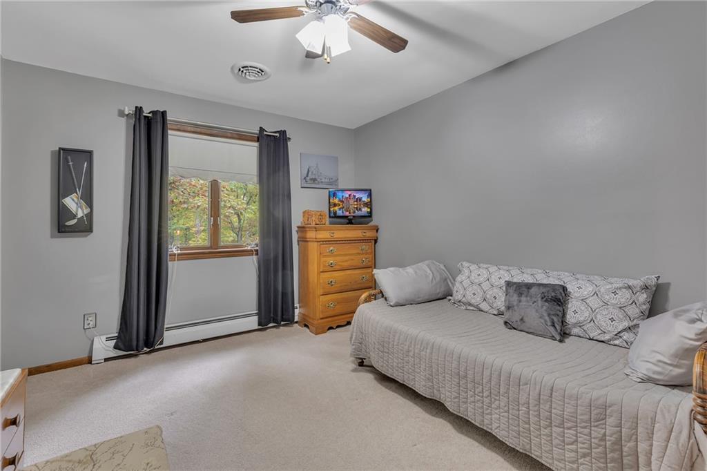 124 Heath Drive Baden, PA 15005 - Photo 21 of 38 a bedroom with a bed and a chandelier