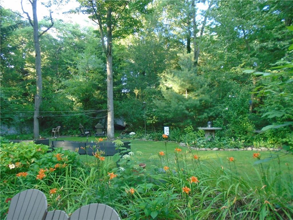 124 Heath Drive Baden, PA 15005 - Photo 28 of 38 a view of a backyard with potted plants and large trees