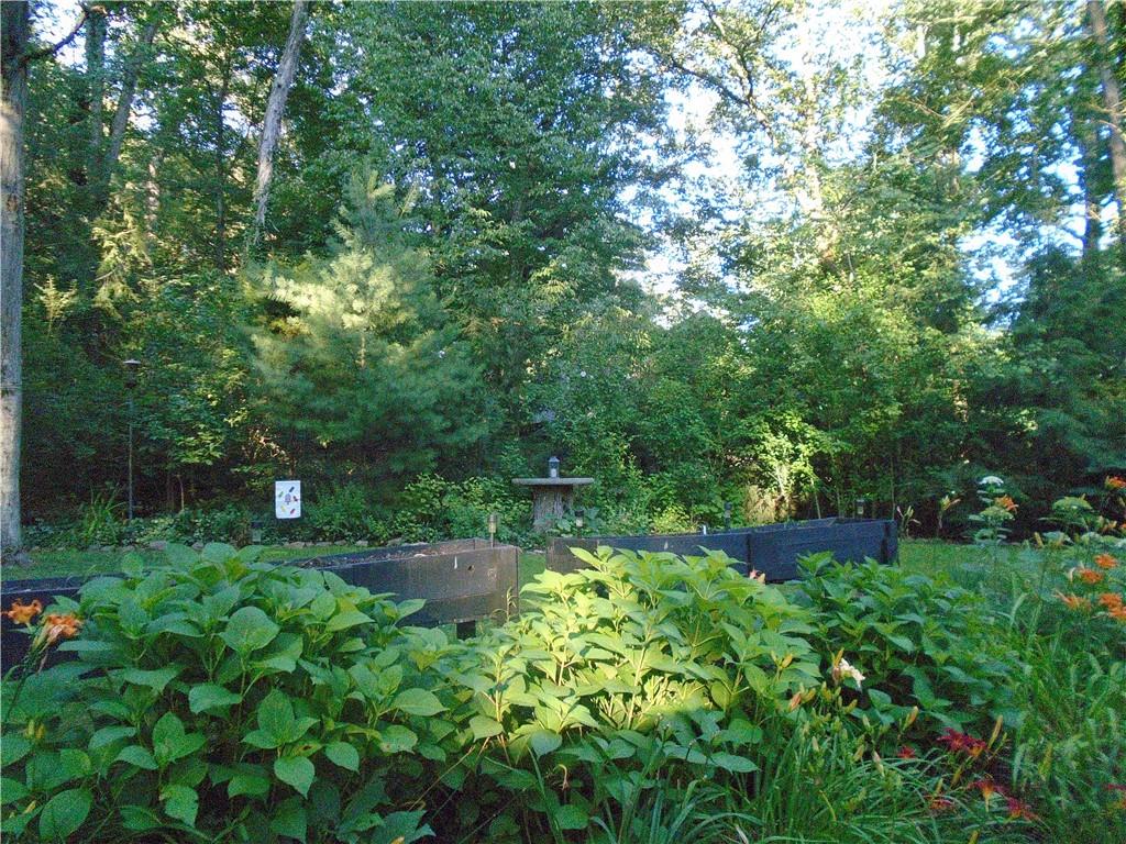 124 Heath Drive Baden, PA 15005 - Photo 30 of 38 a backyard of a house with lots of green space and garden