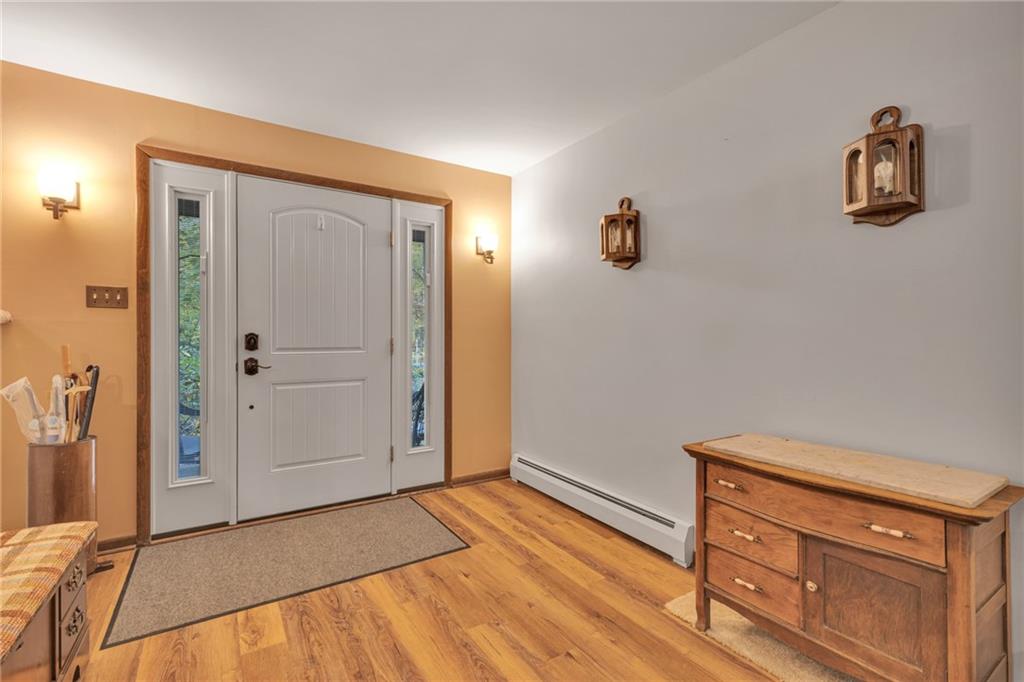 124 Heath Drive Baden, PA 15005 - Photo 3 of 38 an empty room with wooden floor and cabinet